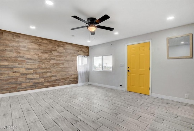spare room with recessed lighting, baseboards, ceiling fan, and an accent wall