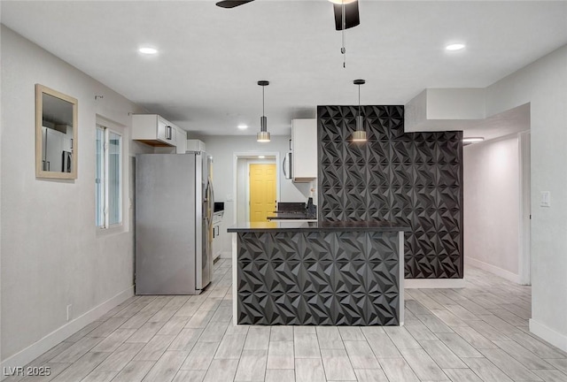 kitchen featuring stainless steel appliances, baseboards, white cabinetry, and light wood-style floors