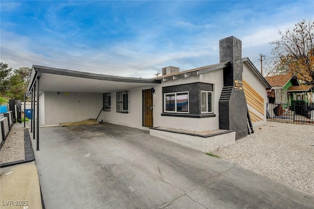 view of front of house with fence and stucco siding