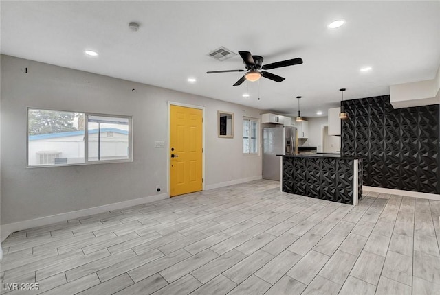 kitchen featuring recessed lighting, ceiling fan, open floor plan, and stainless steel fridge with ice dispenser