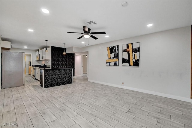 unfurnished living room featuring ceiling fan, light wood-style floors, recessed lighting, baseboards, and visible vents