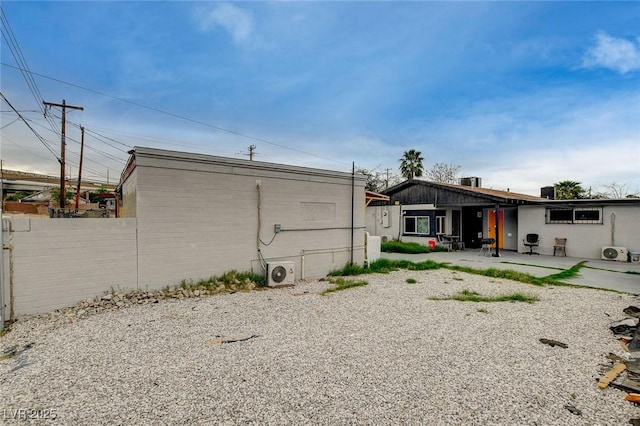 rear view of house featuring ac unit, a patio area, and fence