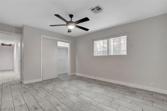 unfurnished bedroom featuring visible vents, baseboards, ceiling fan, and a closet