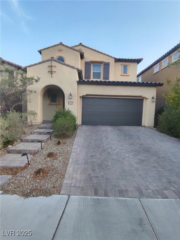 11815 Corenzio Ave, Las Vegas, NV 89138 - mediterranean / spanish-style house with decorative driveway, a garage, and stucco siding