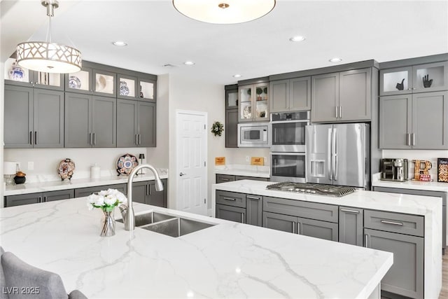 kitchen with gray cabinetry, appliances with stainless steel finishes, and a center island