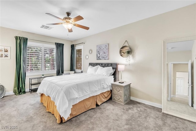 carpeted bedroom with baseboards, ceiling fan, and visible vents