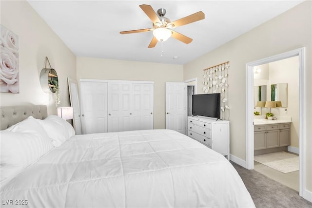 bedroom with ceiling fan, carpet floors, baseboards, a closet, and ensuite bathroom