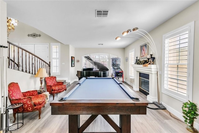 playroom featuring visible vents, a glass covered fireplace, baseboards, light wood-style floors, and pool table