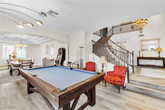 rec room with a chandelier, arched walkways, visible vents, and ornate columns