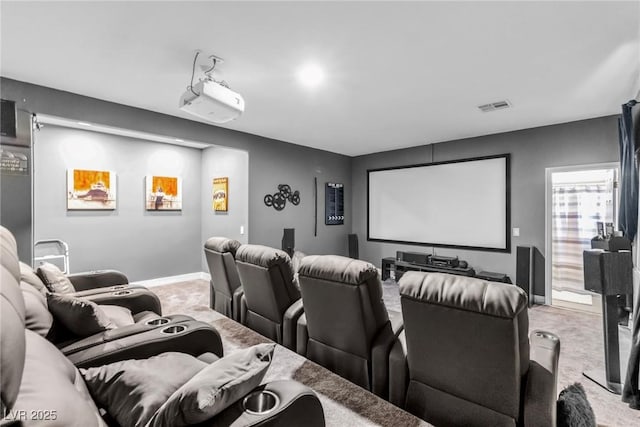 carpeted home theater room with visible vents and baseboards