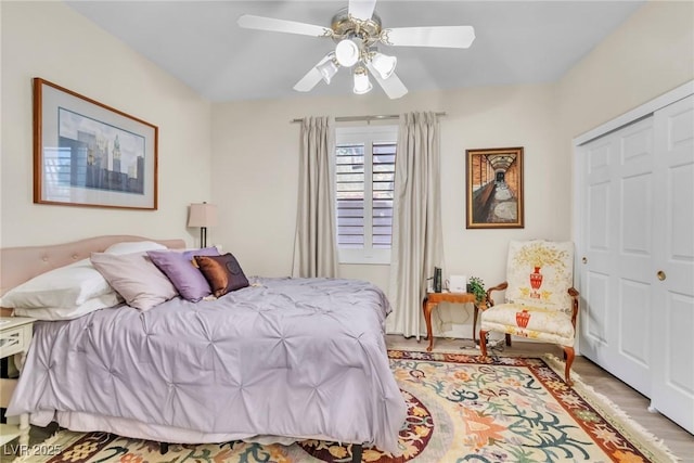 bedroom with ceiling fan, a closet, and light wood finished floors