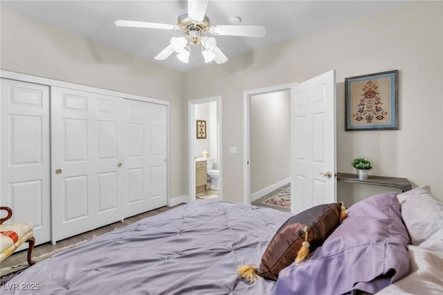 bedroom featuring a closet, baseboards, ceiling fan, and ensuite bath