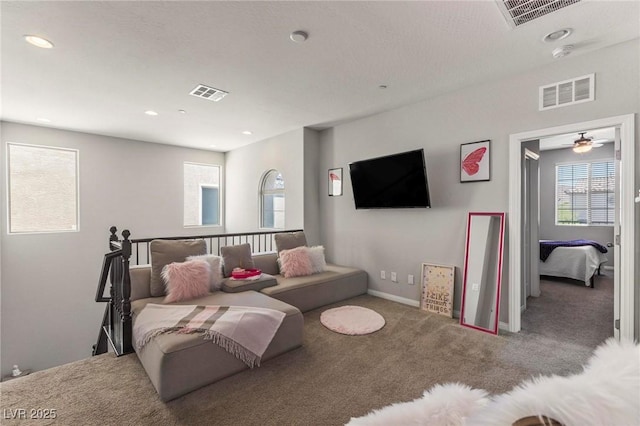 carpeted living room featuring recessed lighting, baseboards, and visible vents