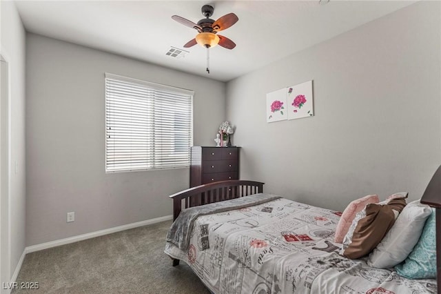 carpeted bedroom with visible vents, a ceiling fan, and baseboards