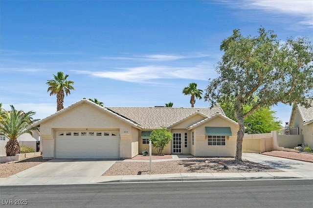 880 Autumn Canyon Way, Henderson, NV 89002 - single story home with a tiled roof, driveway, a garage, fence, and stucco siding