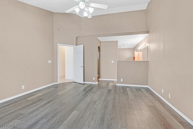 880 Autumn Canyon Way, Henderson, NV 89002 - empty room featuring baseboards, ceiling fan, wood finished floors, and a towering ceiling