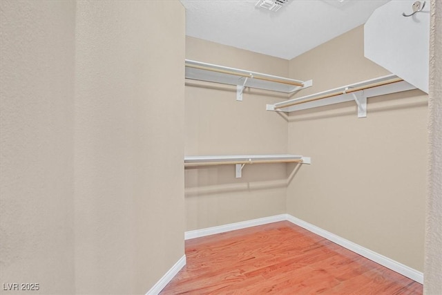 880 Autumn Canyon Way, Henderson, NV 89002 - spacious closet featuring visible vents and light wood finished floors