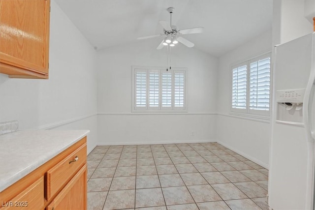 880 Autumn Canyon Way, Henderson, NV 89002 - unfurnished dining area featuring a ceiling fan, light tile patterned floors, and lofted ceiling