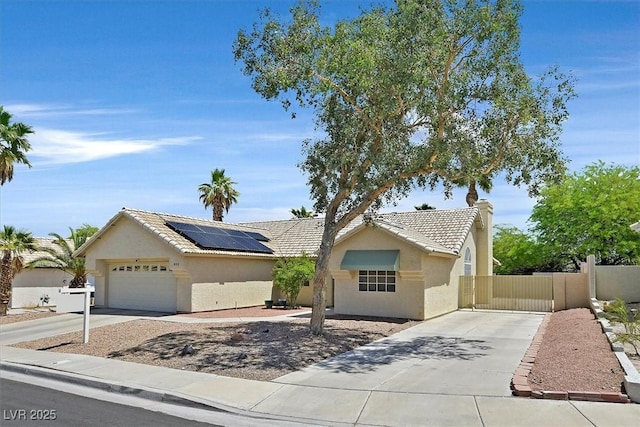 880 Autumn Canyon Way, Henderson, NV 89002 - single story home featuring roof mounted solar panels, stucco siding, driveway, and a tile roof