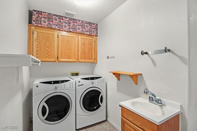 880 Autumn Canyon Way, Henderson, NV 89002 - laundry area with visible vents, light tile patterned flooring, a sink, cabinet space, and independent washer and dryer