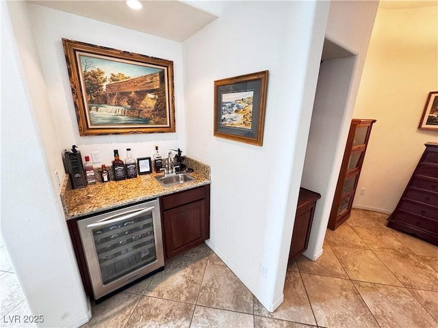 bar featuring wine cooler, light tile patterned floors, indoor wet bar, and a sink