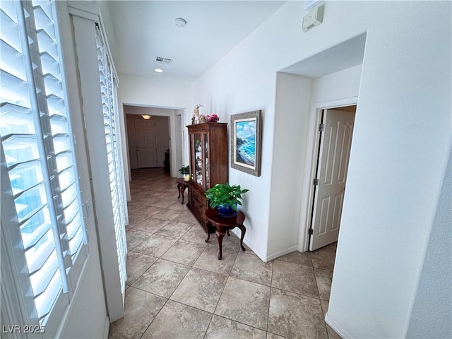 corridor featuring visible vents and baseboards