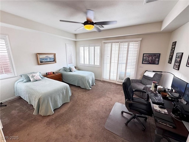 carpeted bedroom featuring baseboards and a ceiling fan