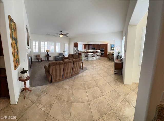 living area featuring a ceiling fan and light tile patterned floors