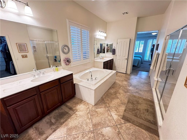 ensuite bathroom with a sink, ensuite bathroom, visible vents, a bath, and a stall shower