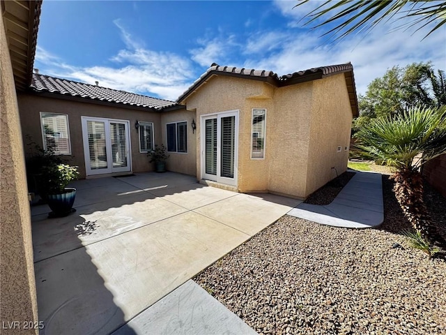 6134 Burleson Ranch Rd, Las Vegas, NV 89131 - back of house with stucco siding, a tile roof, and a patio