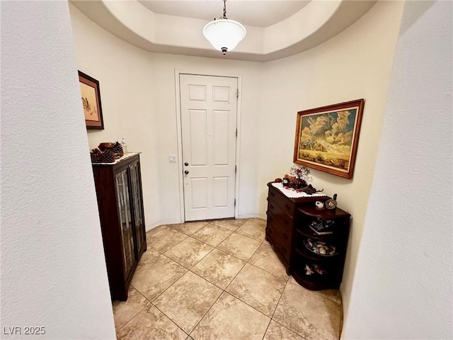 6134 Burleson Ranch Rd, Las Vegas, NV 89131 - corridor featuring light tile patterned flooring and a tray ceiling