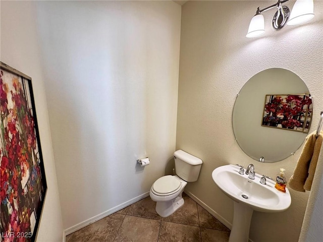 6134 Burleson Ranch Rd, Las Vegas, NV 89131 - half bathroom featuring tile patterned flooring, toilet, and baseboards