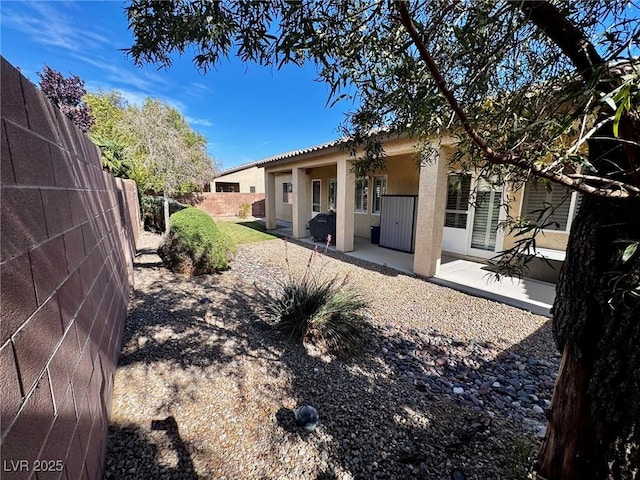 6134 Burleson Ranch Rd, Las Vegas, NV 89131 - back of property with stucco siding and a patio area