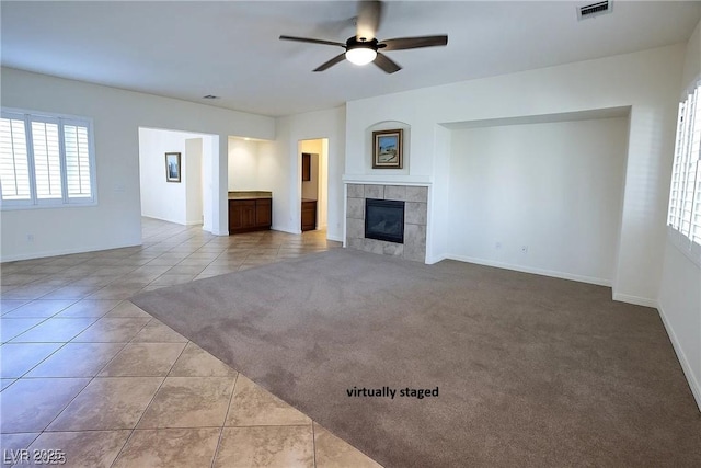 6134 Burleson Ranch Rd, Las Vegas, NV 89131 - unfurnished living room featuring ceiling fan, a fireplace, and tile patterned floors