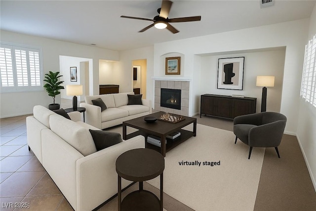 6134 Burleson Ranch Rd, Las Vegas, NV 89131 - tiled living room featuring ceiling fan, healthy amount of natural light, and a fireplace