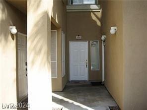 entrance to property with stucco siding