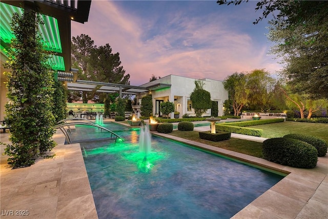 pool at dusk featuring a lawn