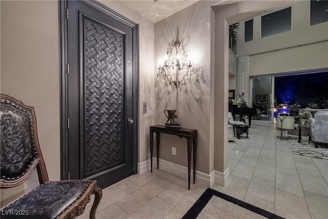 entrance foyer featuring baseboards and light tile patterned floors
