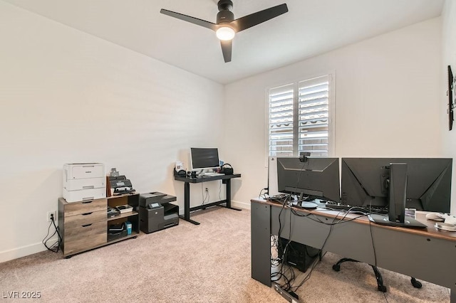 home office with carpet flooring, a ceiling fan, and baseboards