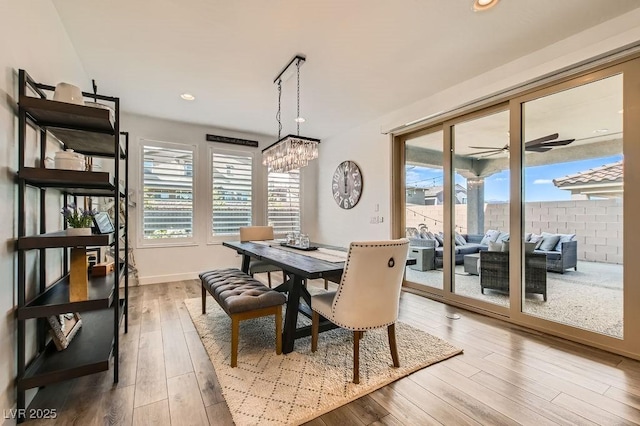 dining area featuring recessed lighting, baseboards, ceiling fan with notable chandelier, and hardwood / wood-style flooring