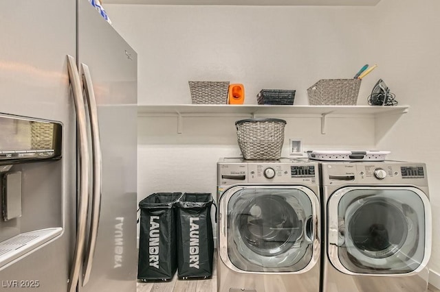 laundry area with laundry area, wood finished floors, and washing machine and clothes dryer