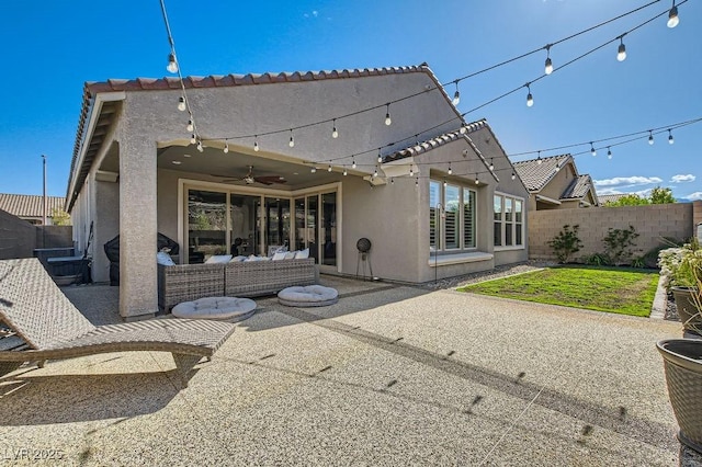 back of property featuring an outdoor hangout area, fence, a patio, and stucco siding