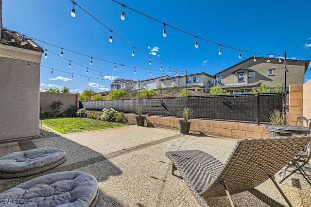 view of patio / terrace with a fenced backyard and a residential view
