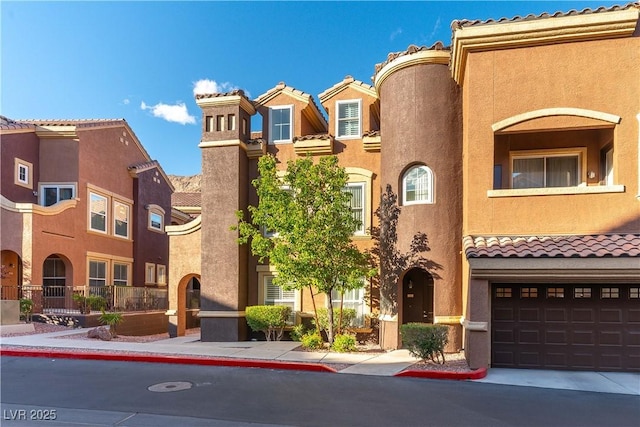 view of front of home featuring a residential view, stucco siding, and a tile roof