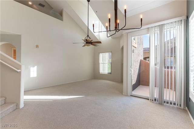 unfurnished dining area featuring carpet, a notable chandelier, stairs, and visible vents