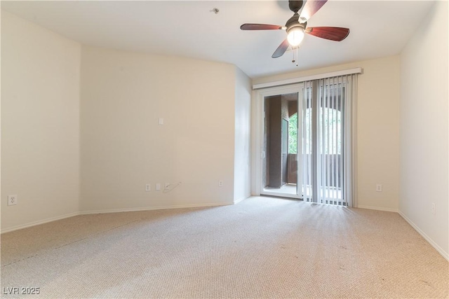 empty room featuring baseboards, a ceiling fan, and carpet