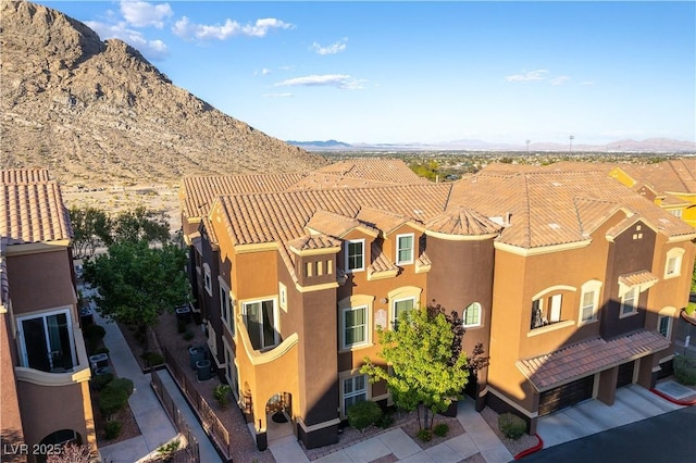 exterior space featuring a mountain view and stucco siding