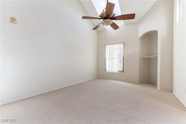 unfurnished bedroom featuring high vaulted ceiling, baseboards, carpet flooring, and ceiling fan