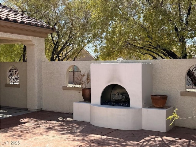 view of patio featuring exterior fireplace