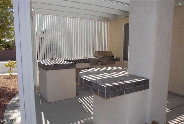 view of patio with an outdoor kitchen and grilling area